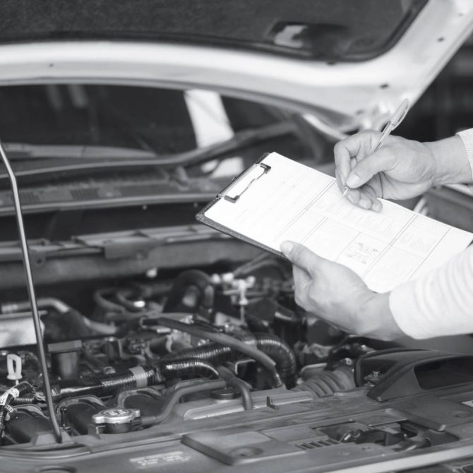 Mechanic engineer hand holding checklist paper and taking a note
